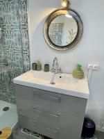 a bathroom with a sink and a mirror at Le Planzollais in Planzolles