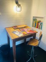 a wooden table with a chair and books on it at Le Planzollais in Planzolles