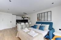 a bedroom with a blue bed and a kitchen at 322 Suite Fes - Superb apartment in Suresnes