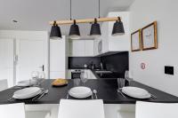 a kitchen with a black table with white chairs at 322 Suite Fes - Superb apartment in Suresnes