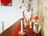 a table with candles and red flowers on it at Gîte Le Bernard, 6 pièces, 10 personnes - FR-1-426-164 in Le Bernard