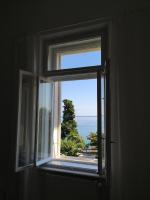 an open window with a view of the ocean at Villa Peppina Apartment in Lovran