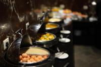 a buffet line with bowls of eggs and other food at Hotel Dolmaling in Kathmandu