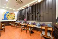 a row of tables and benches in a restaurant at Villa De Pranakorn in Bangkok