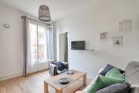 a living room with a couch and a table at Flowers Power - Appt pour 2 in Vitry-sur-Seine