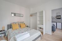 a white bedroom with a bed with yellow pillows at Flowers Power - Appt pour 2 in Vitry-sur-Seine