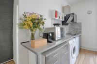 a kitchen with a counter with a vase of flowers at Flowers Power - Appt pour 2 in Vitry-sur-Seine