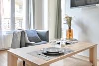 a living room with a table with a plate on it at Flowers Power - Appt pour 2 in Vitry-sur-Seine