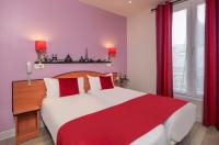 a bedroom with a large white bed with red sheets at Grand Hôtel De Turin in Paris