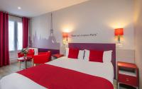 a bedroom with a red and white bed and red chairs at Grand Hôtel De Turin in Paris