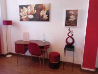 a room with a table and two chairs and a painting at Brà Guest House in Verona