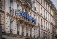 a building with a sign on the side of it at Grand Hôtel De Turin in Paris