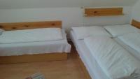 A bed or beds in a room at Penzión U Johna