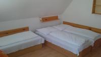 A bed or beds in a room at Penzión U Johna