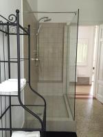 a shower with a glass door in a bathroom at Villa Peppina Apartment in Lovran