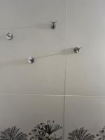 a shower with three lights on a white wall at Le petit coin de Paradis in Varaville