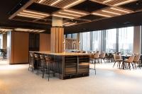 a conference room with tables and chairs and a bar at Scandic Hamar in Hamar