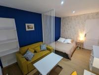 a small room with a bed and a couch at Le Majorelle-centre ville-accès 24h- parking free in Montluçon