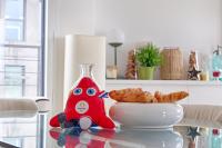 a red toy sitting on a table next to a bowl of pastries at Resident- Beautiful 6P apartment in Montrouge