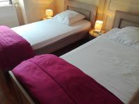 two beds sitting next to each other in a room at Gite au sein du Parc des Volcans d&#39;Auvergne, tous commerces à pied in Neussargues-Moissac
