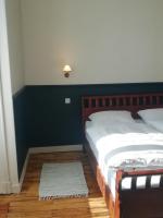a bedroom with a bed with a blue accent wall at Thunder Roadhouse in La Mothe-Saint-Héray