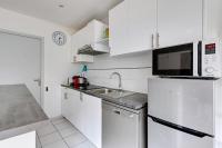 a white kitchen with a sink and a microwave at 236 Home Rome Concept in Paris