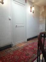 a white door in a room with a red rug at Thunder Roadhouse in La Mothe-Saint-Héray
