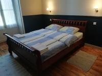 a bedroom with a large bed with blue sheets and pillows at Thunder Roadhouse in La Mothe-Saint-Héray