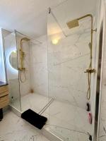 a bathroom with a shower with a glass door at Appartement cosy de standing in Mondonville