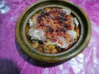 a green bowl of food on a purple table at Gite chez Ali Agouti Maison Berbère in Agouti