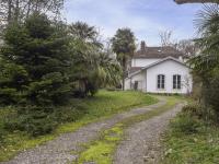 a gravel road in front of a white house at Holiday Home Le chant des milans by Interhome in Ondres