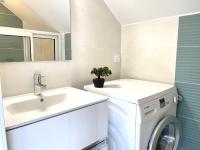 a bathroom with a washing machine and a sink at Apartment Claire-4 by Interhome in Arcachon