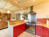 a large kitchen with red cabinets and a stove at Gîte Saint-Christophe-en-Champagne, 5 pièces, 8 personnes - FR-1-410-192 in Saint-Christophe-en-Champagne