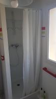 a white shower with a shower curtain in a bathroom at Chez Laurence &amp; RV in Vauréal