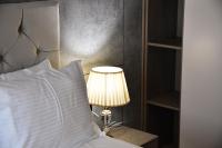 a lamp on a table next to a bed at Hotel Building Stefan Resort I in Mamaia Sat&#47;Năvodari