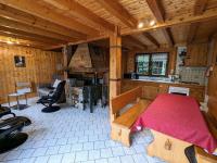 a room with a table and a kitchen in a cabin at Gîte Anould, 4 pièces, 6 personnes - FR-1-589-2 in Anould