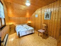 a bedroom with a bed in a wooden cabin at Gîte Anould, 4 pièces, 6 personnes - FR-1-589-2 in Anould