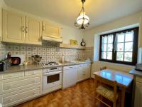 a kitchen with white cabinets and a table in it at Gîte Saint-Haon, 4 pièces, 5 personnes - FR-1-582-211 in Saint-Haon