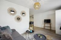 a living room with a couch and two tables at 852 Suite Élégante - Superb Apartement in Asnières-sur-Seine