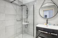 a bathroom with a shower and a sink and a mirror at 199 Suite Monopoly - Superb Apartment in Paris in Paris
