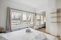 a bedroom with a bed and a large window at 199 Suite Monopoly - Superb Apartment in Paris in Paris