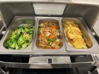 three trays of food in an open refrigerator at Paragon House and Residence in Hanoi