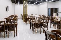 an empty restaurant with wooden tables and chairs at PGA Hotel Free Shuttle to Airport in Tashkent