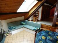 an attic room with a couch and a window at Piet in Laruns