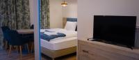 A bed or beds in a room at Napsugár Club és Panzió