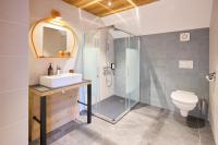 a bathroom with a shower and a sink and a toilet at Hotel Base Camp Lodge - Albertville in Albertville