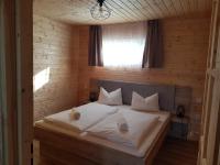 A bed or beds in a room at Napsugár Club és Panzió