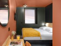 a bedroom with a bed and two windows at Eklo Paris Expo Porte de Versailles in Vanves