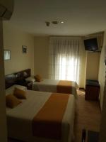 A bed or beds in a room at Hotel Complutense