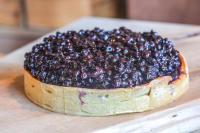 a blueberry pie sitting on top of a wooden table at Hotel Base Camp Lodge - Albertville in Albertville